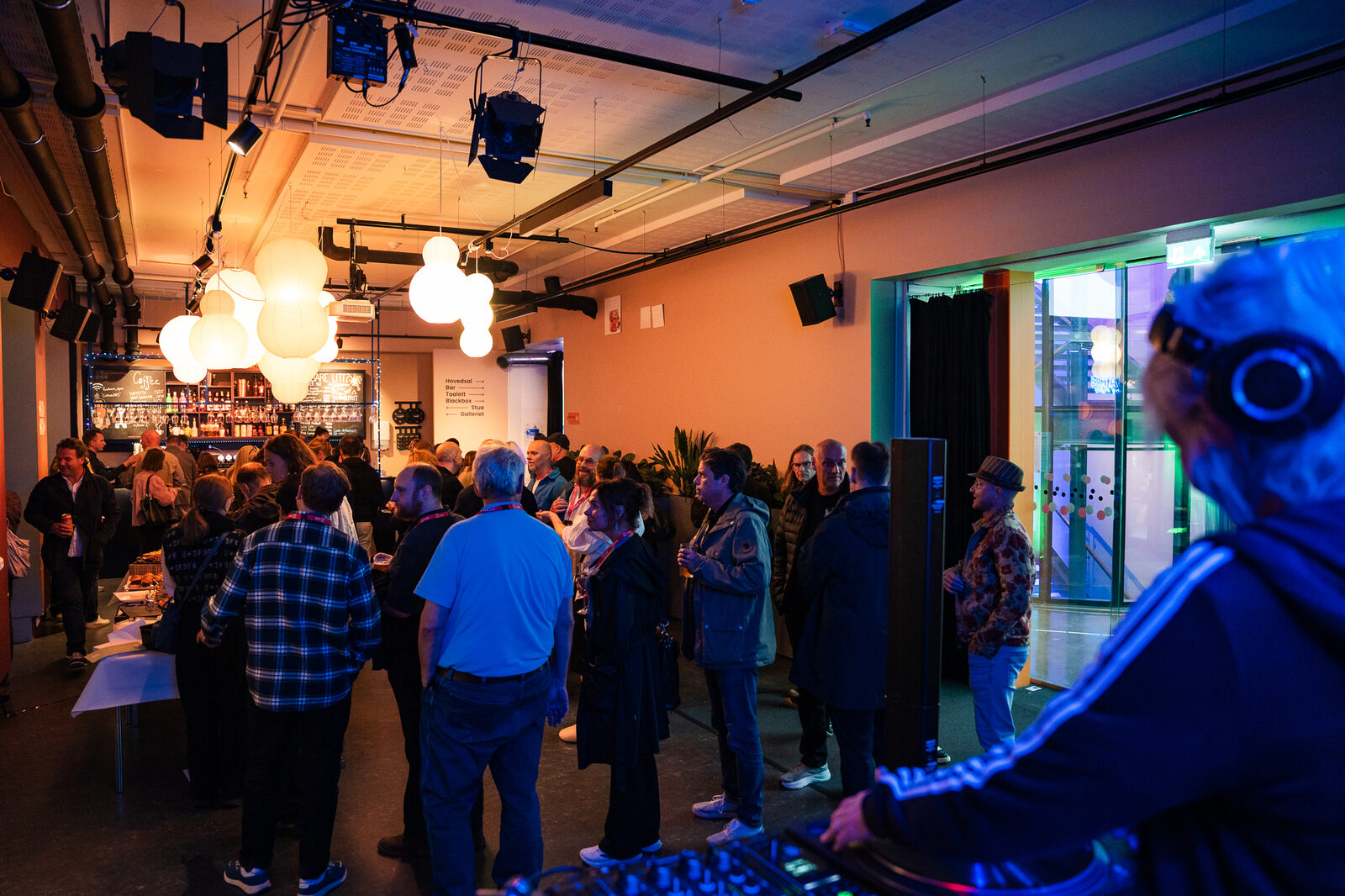 Guests filling the hall at Kraftverk under coloured lights
