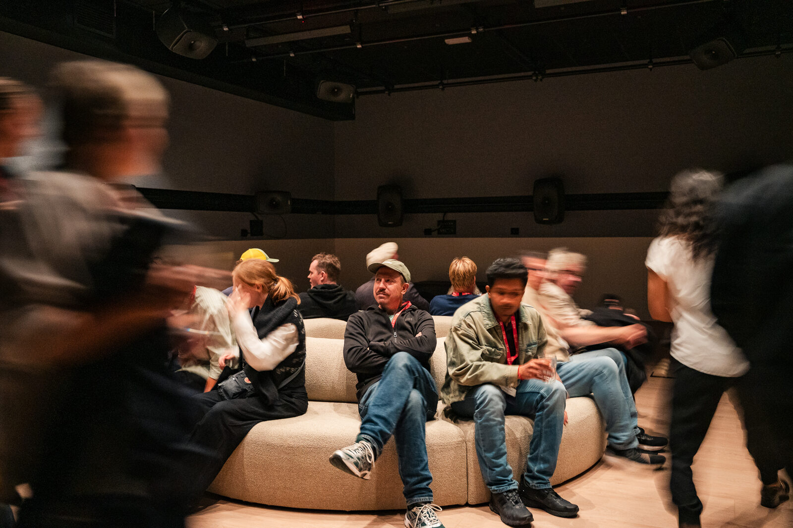 Visitors on a round sofa in the installation room