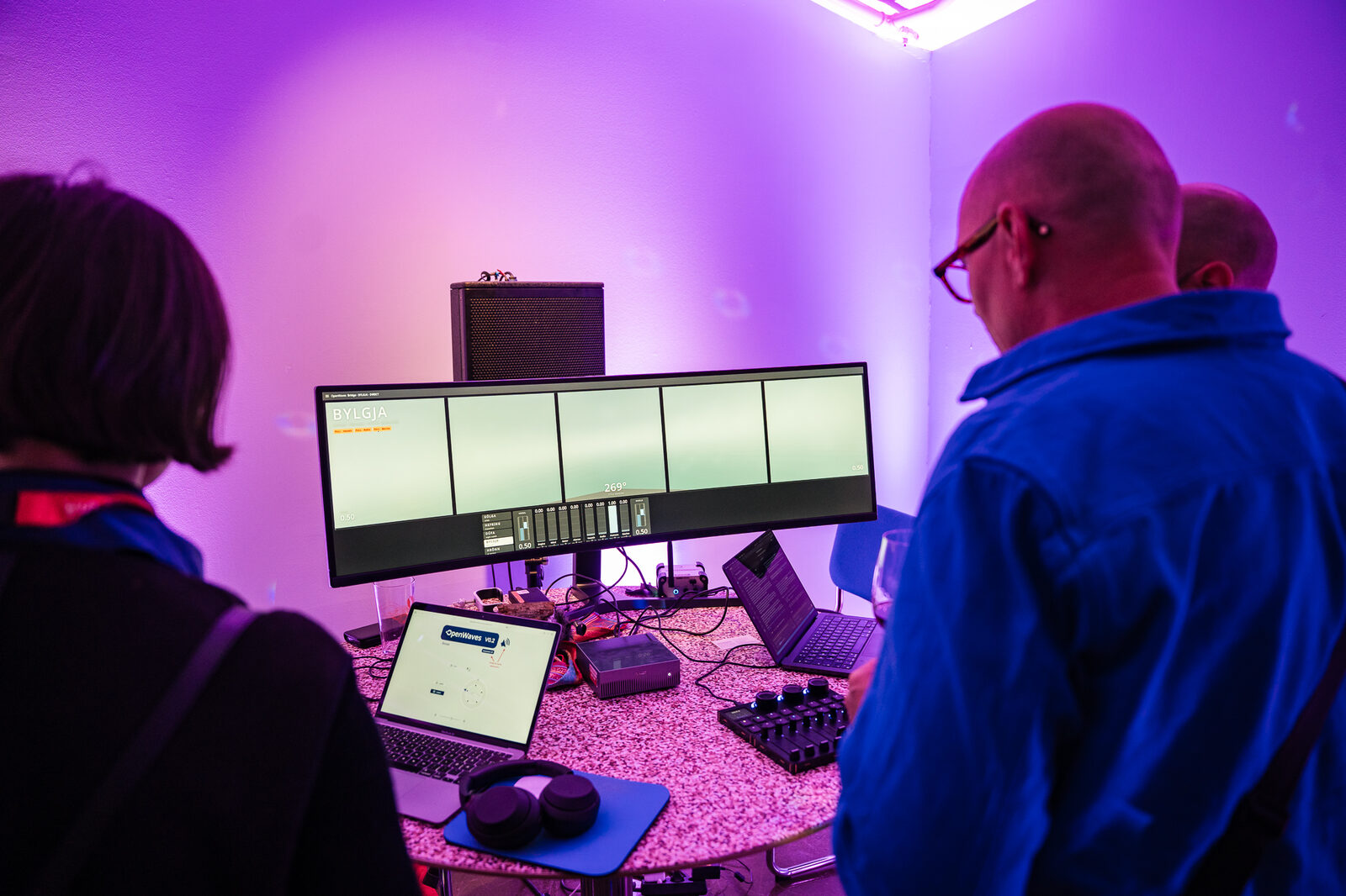 A participant studying an installation on a bank of screens