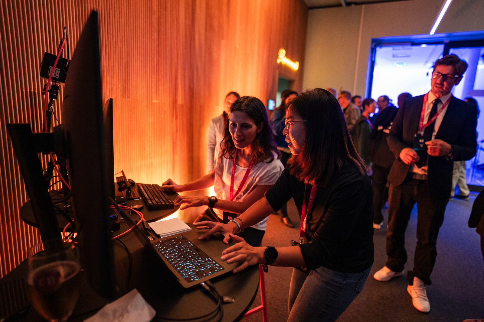 Two visitors trying an installation on a laptop