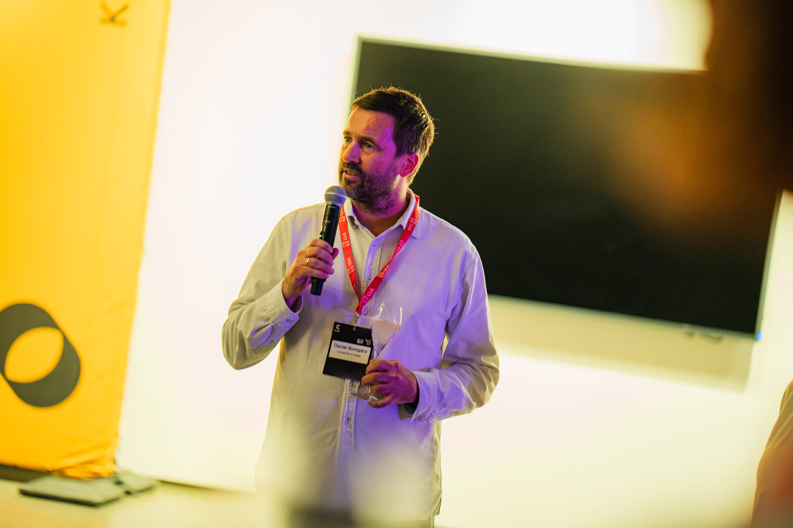 A host welcoming the guests with a microphone