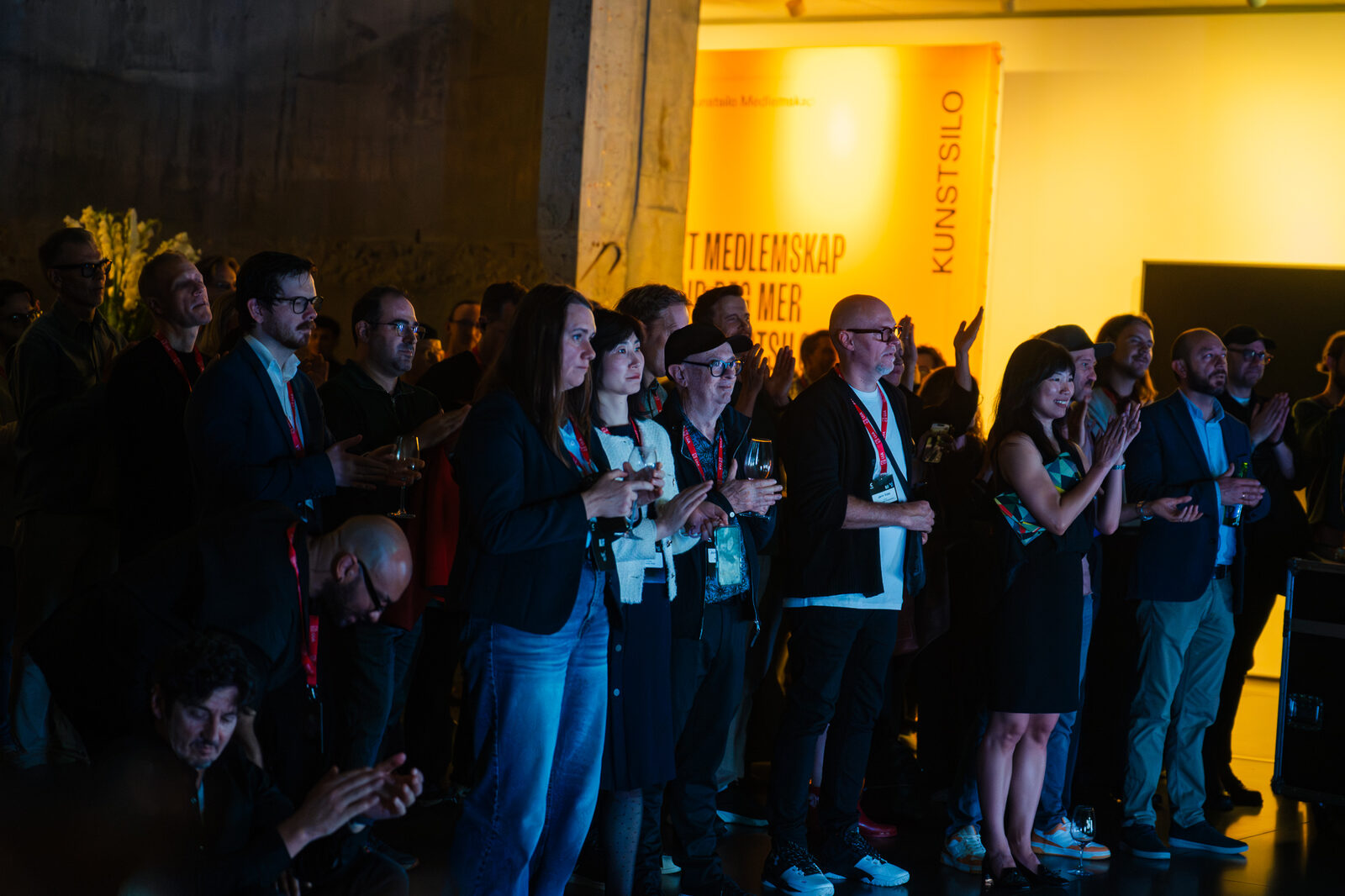 The audience in the silos lit in yellow during the performance